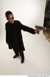 Man Adult Average Black Fighting with gun Standing poses Coat